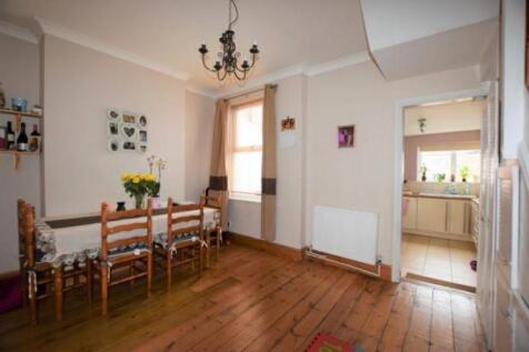 A charming living room featuring a wooden dinin...