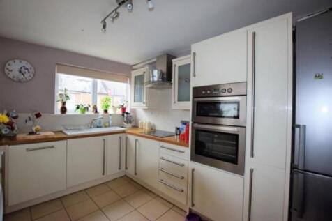 Bright and modern kitchen featuring ample natur...