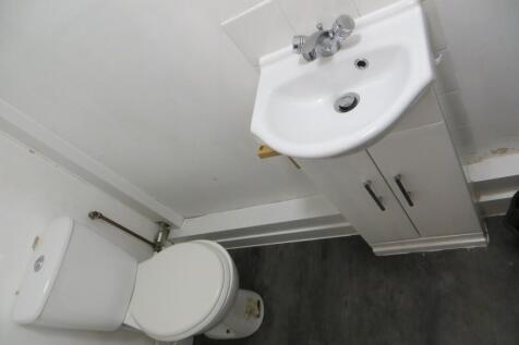 Compact and functional toilet area featuring a ...