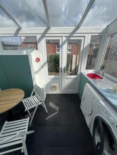 Bright and airy kitchen area with a glass ceili...