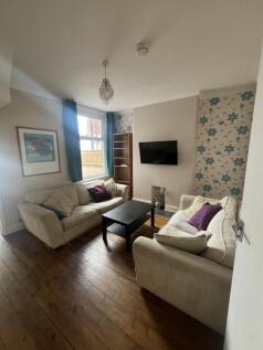 Cozy living room featuring two comfortable crea...