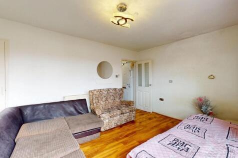 A cozy living room featuring light hardwood flo...