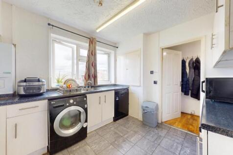 Bright and modern kitchen featuring ample natur...