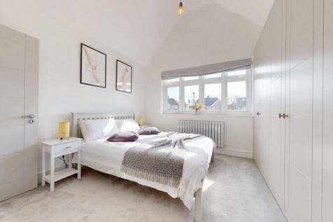 Bright and spacious master bedroom featuring a ...