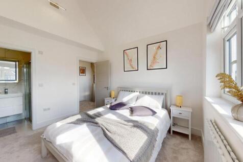 Bright and spacious master bedroom featuring a ...