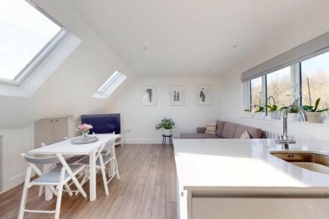 Bright and airy living room with modern white d...