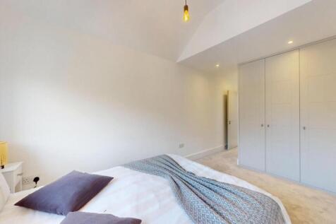 A bright and spacious master bedroom featuring ...