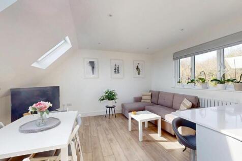Bright and modern living room featuring a spaci...