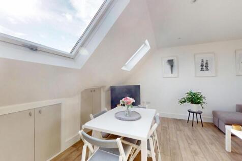 A bright and airy living room with modern furni...