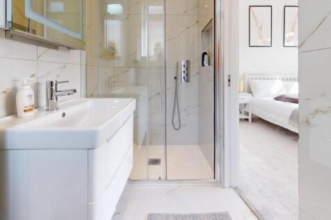 Bright and modern bathroom suite featuring a st...