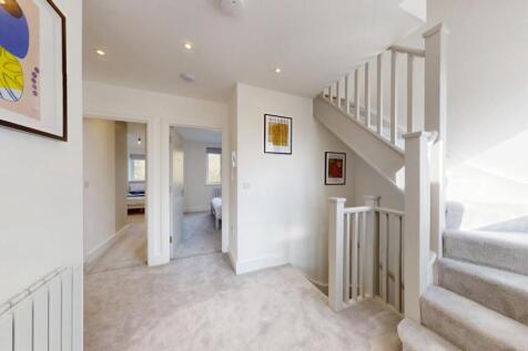 Bright and spacious hallway featuring neutral c...
