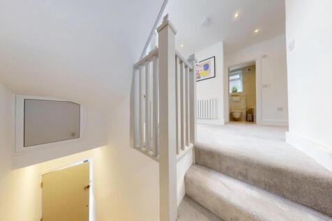 Bright and clean staircase with soft carpeting ...