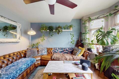 A bright and inviting living room featuring a c...