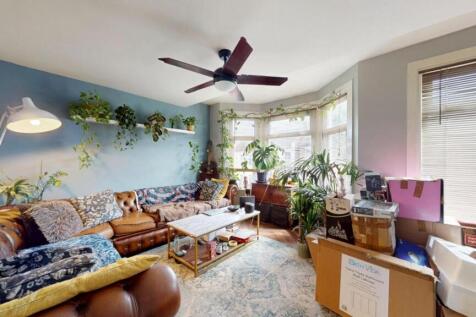 A bright and welcoming living room featuring a ...