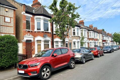 A picturesque street view featuring a row of ch...