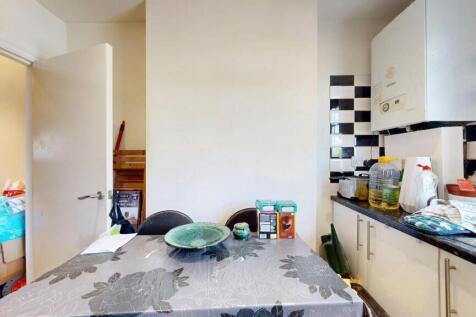 Bright kitchen area featuring contemporary blac...