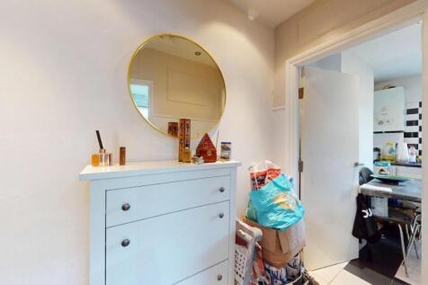 A clean and bright hallway featuring a white ch...