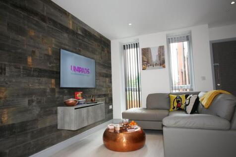 A modern living room featuring a cozy grey leat...