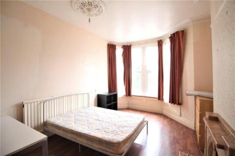 A bright double bedroom featuring a large bay w...