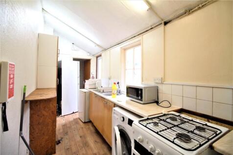 A compact kitchen featuring essential appliance...