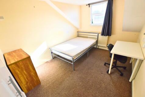 A bright and tidy single bedroom featuring a co...