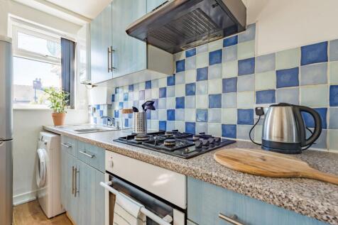 Bright and tidy kitchen featuring a colorful bl...