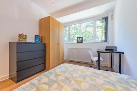 A clean and bright single bedroom featuring a l...