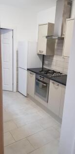 A modern kitchen featuring sleek cabinetry, a b...