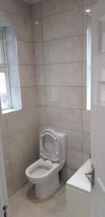 Bright and clean single toilet featuring modern...