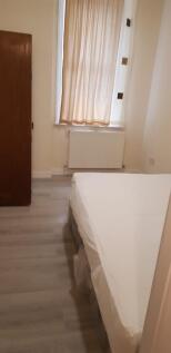 A simple, clean room with soft natural light fi...