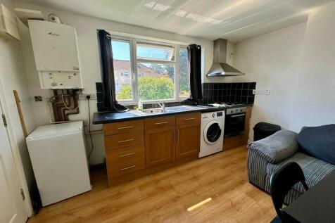 Bright kitchen with a large window offering nat...