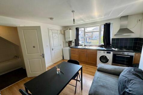 Bright kitchen space featuring a large window t...