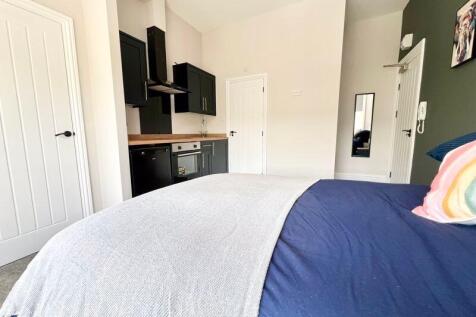 Bright and spacious master bedroom featuring a ...