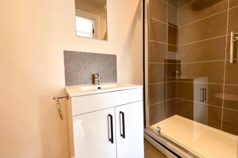A modern bathroom featuring a sleek vanity unit...