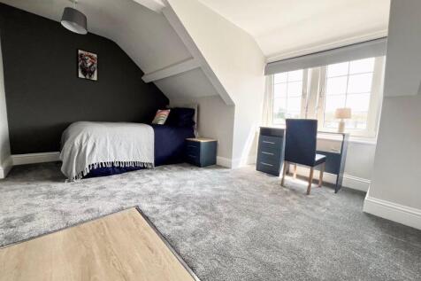 A bright and spacious master bedroom featuring ...