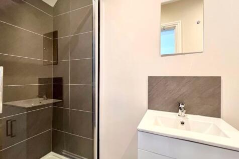 Modern bathroom suite featuring a stylish glass...
