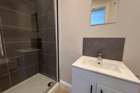 A modern bathroom featuring a sleek shower encl...