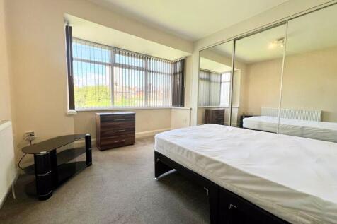 Bright and spacious master bedroom featuring a ...