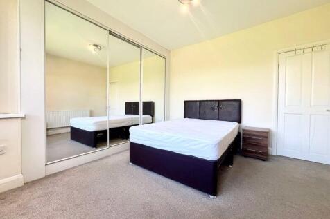 A bright and tidy double bedroom featuring a co...