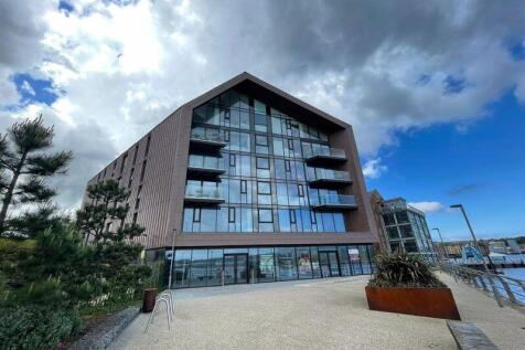 Modern terraced property with sleek glass balco...