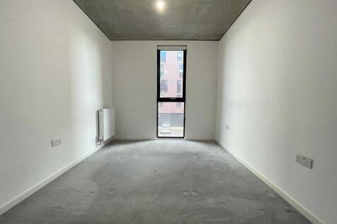 A clean, minimalistic small room with a tall wi...