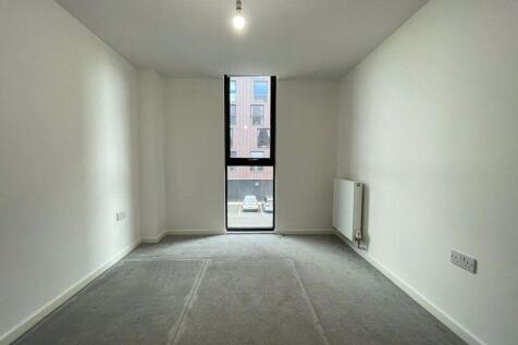 A bright and clean single bedroom featuring a t...