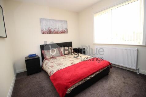 Cozy double bedroom featuring a comfortable bed...