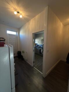 A bright, clean hallway featuring modern dark f...