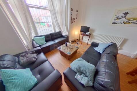 A cozy and inviting living room featuring three...