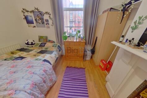 A cozy single bedroom with a comfortable bed, a...