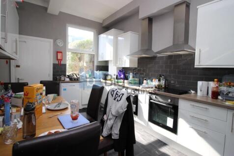 Bright and modern kitchen featuring white cabin...