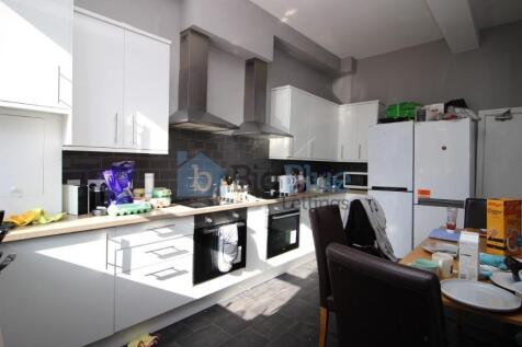 Bright and modern kitchen featuring white cabin...
