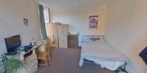 Bright and welcoming bedroom featuring a cozy d...