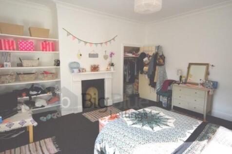 A bright and inviting master bedroom featuring ...